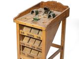 a small wooden table with a bunch of shoes on it