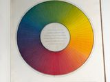 an open book with a picture of a rainbow wheel on it