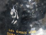 un vase noir surmonté d'un chapeau marron