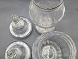 a glass jar with a lid and a glass cup with a lid