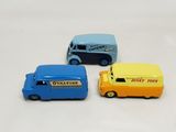 three toy cars sitting next to each other on a white surface