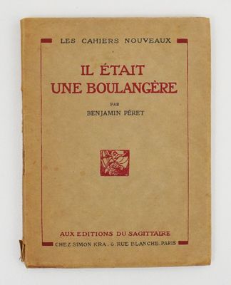 an old book with a red cover on it sitting on a table