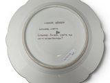 a white plate with a quote on it sitting on a table