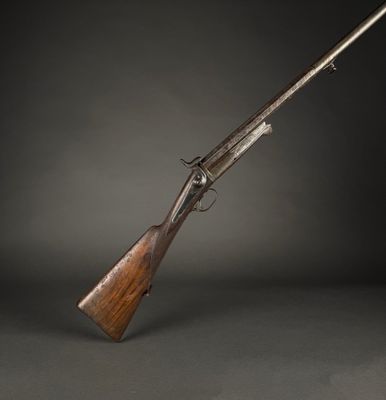 a rifle with a wooden handle on a black background