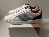 men ' s adidas sneakers in white with blue stripes on the side