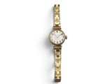 a woman ' s wrist watch with a gold bracelet and a white dial