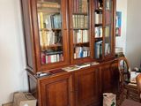 a room with a bookcase, a desk, and a chair in it