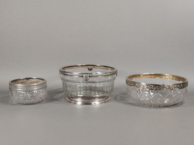 a group of three silverplated dishes and cups