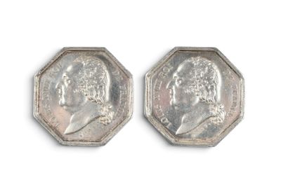 two pieces of silver coin with a portrait of a man on it