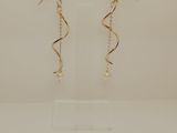 a pair of earrings on a display stand with a price tag