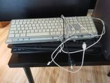 a computer keyboard and a laptop on a black table