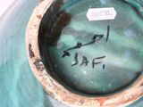 a close up of a vase with a tag on it