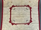 a red and white quilt with a square design on it