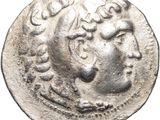 a silver coin with a man ' s face on it