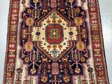 a large rug with a geometric design on a white floor