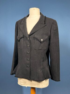 grey jacket on a mannequin base on a blue background