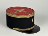 a black hat with a red and gold design on it
