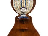 a large vase on a wooden stand on a white background