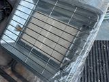 a heater sitting on the ground next to a pile of other items