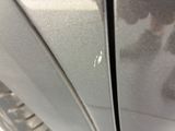 a close up of a car ' s door handle with a sticker on it
