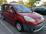 a red van parked in a parking lot next to other cars