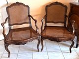 two chairs sitting next to each other on a tile floor