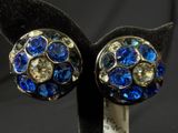 pair of blue and clear crystal stud earrings on black velvet