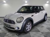 a picture of a white mini cooper parked in a garage