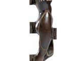 bronze statue of a woman holding a cell phone to her ear