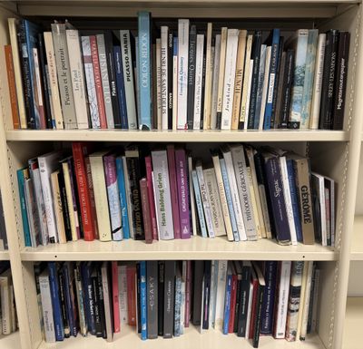 a bookshelf with many books on it in a library