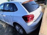 a small white car that is parked in a lot