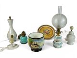 a lot of different vases and lamps on the table
