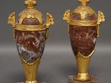 pair of gold and red marble urns on marble bases