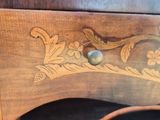 a close up of a wooden desk with a bird on it