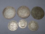 a group of five silver coins sitting on top of a table