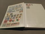 an open book with stamps on it sitting on a table