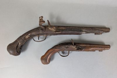 DEUX PISTOLETS à silex, l'un à pans au tonnerre avec traces de dorure.