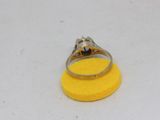 an image of a yellow sponge with a silver ring on top of it