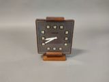 a small clock that is sitting on a table