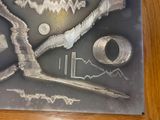 a picture of a metal sign with a picture of scissors and other items