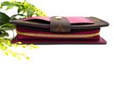 purple and black wallet with zippers and flowers on white background