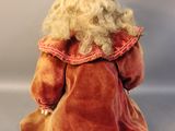 a doll that has a crown on it ' s head