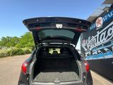 the back of a car with its trunk open in a parking lot