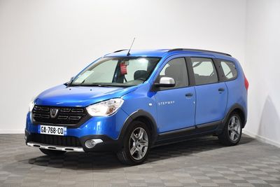 the small blue car is parked in a room with a checkered floor