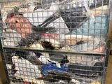 a metal cart with a bunch of clothes in it