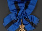 an image of a blue and black ribbon with a gold star on it