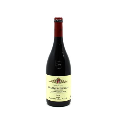 a bottle of red wine sitting on top of a white table