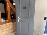 a grey door in the corner of a room