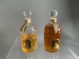 two bottles of alcohol sitting on a clear table