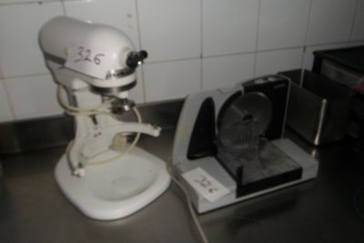 a white mixer sitting on a counter next to a toaster